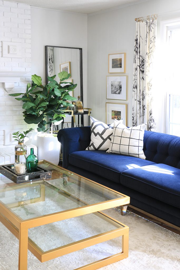 Living room with blue sofa and black mirror