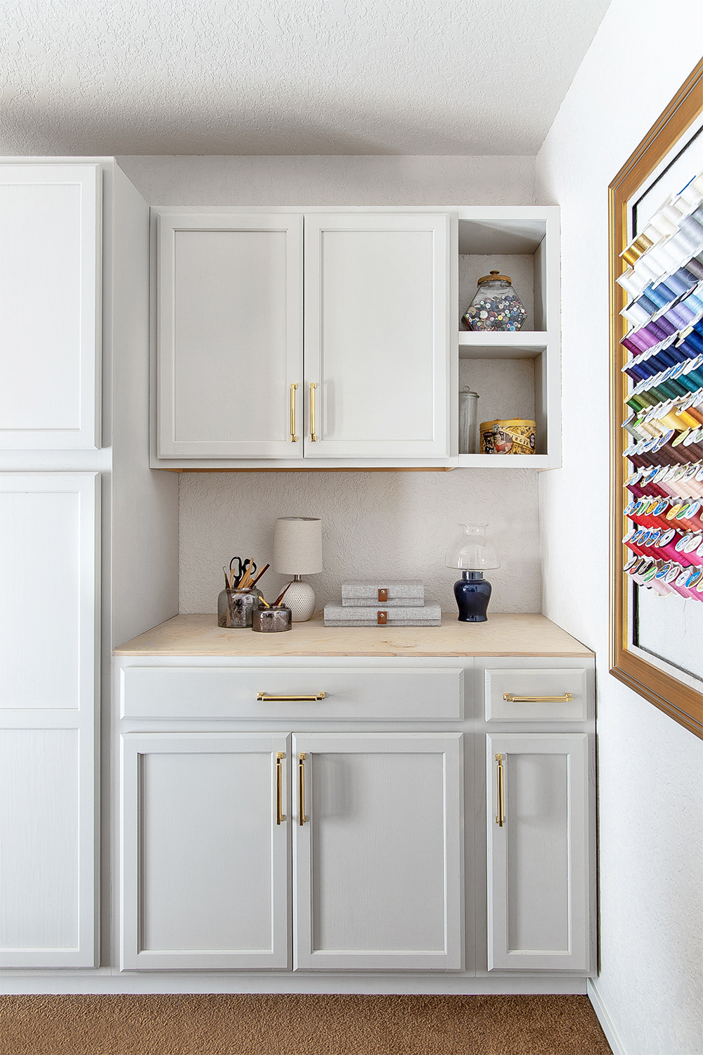 sewing room with spools of thread on wall