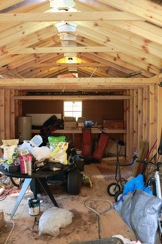 messy shed with small window that will be replaced by French doors